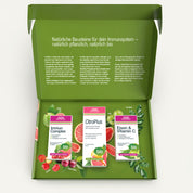 Eine geöffnete grüne Schachtel von gse organic supplements zeigt das Immun Boost Paket mit drei Nahrungsergänzungsmitteln - Immun Complex, CitroPlus und Eisen & Vitamin C - inmitten von Früchten und Blättern; der deutsche Text im Inneren unterstützt Immunsystem stärken.