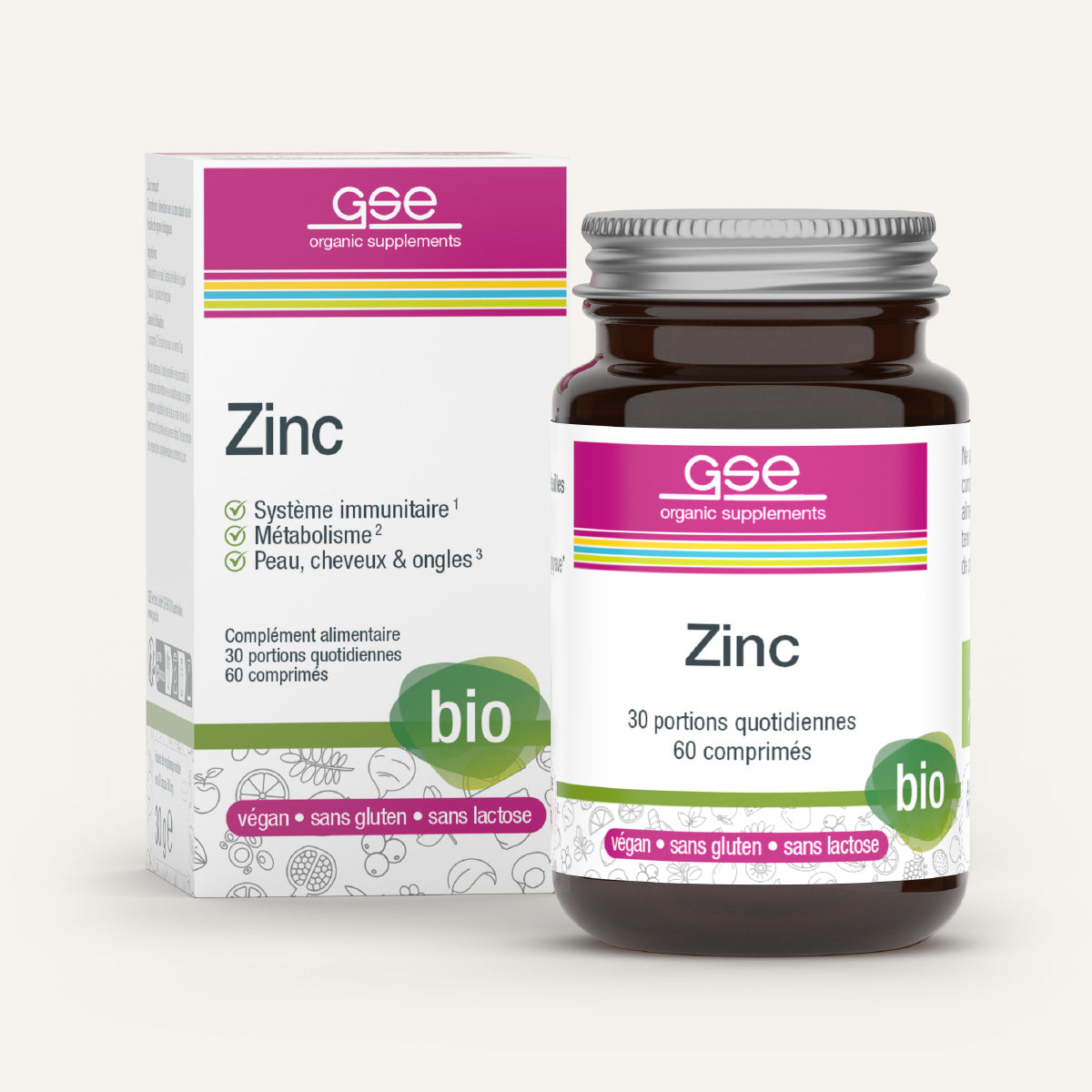 Eine braune Flasche gse.organic.supplements Zink Compact (Bio) FR steht neben einer weiß-rosa Schachtel, die die Vorteile für Immunität, Stoffwechsel, Haut, Haare und Nägel hervorhebt. Die Verpackung ist mit den Symbolen "bio", "vegan", "glutenfrei" und "laktosefrei" versehen.